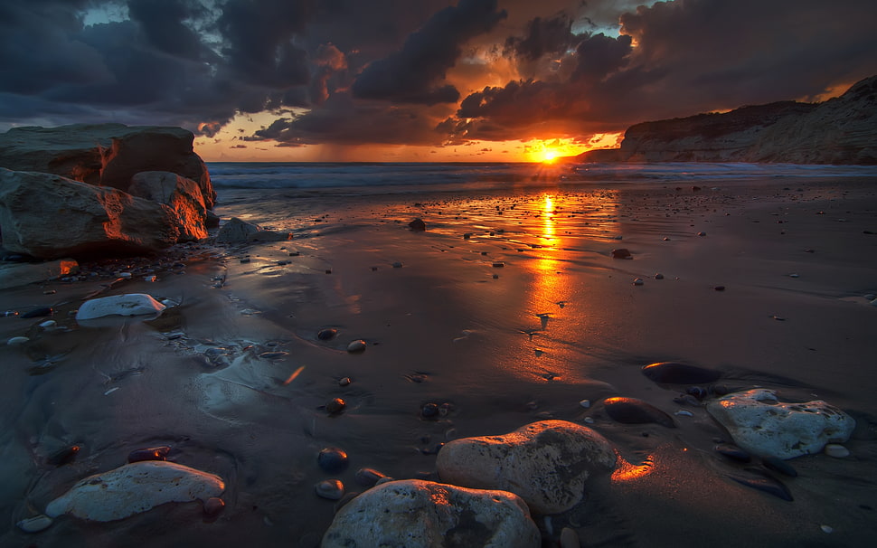 rocks on seashore under cloudy sky during golden hour HD wallpaper