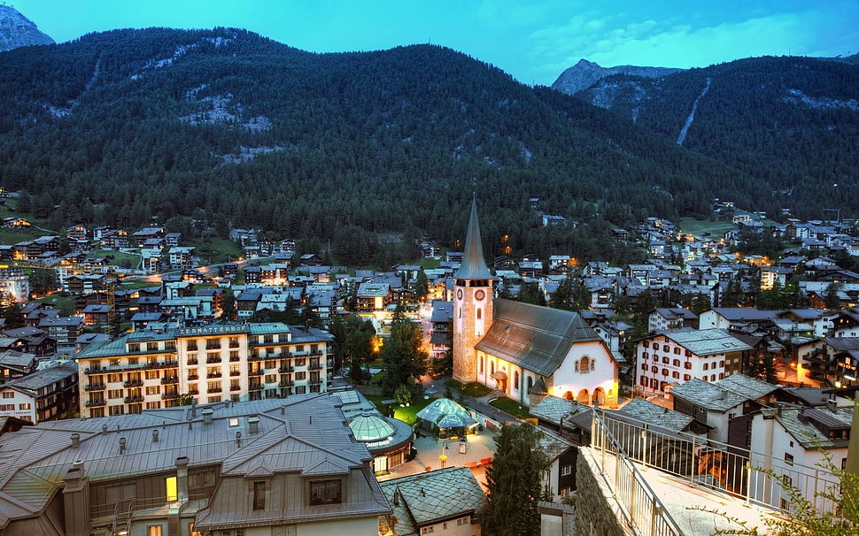 aerial photo of village near mountain HD wallpaper