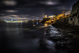 timelapse photography of cityscape beside sea during nighttime, valletta, malta HD wallpaper