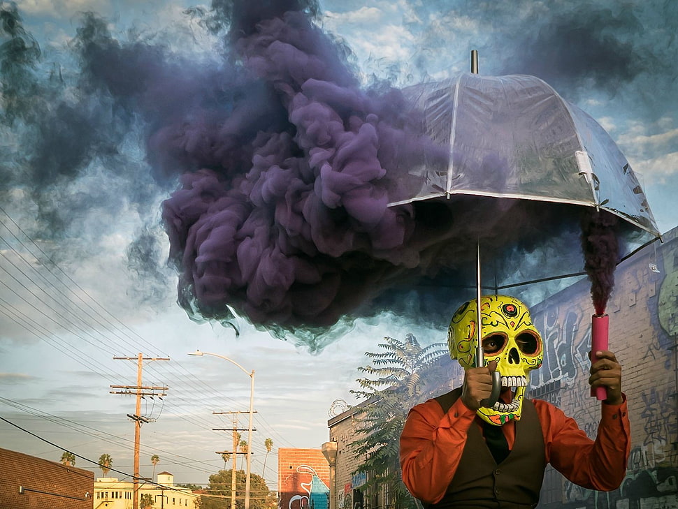 man wearing yellow calavera mask while holding umbrella HD wallpaper