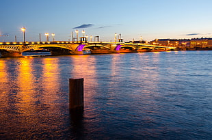 photo of bridge on body of water during golden hour, blagoveshchensky bridge