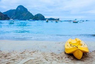 yellow kayak on the seashore painting