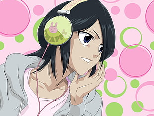 female anime character with black hear wearing green and pink headset