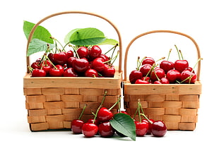 pile of cherry fruits with two wicker baskets