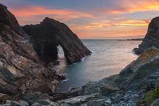 arch rock structure beside ocean HD wallpaper