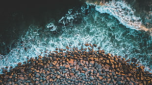 top view photo of gravels and ocean wave photo