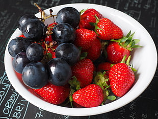 strawberry and blueberry on white ceramic bowl