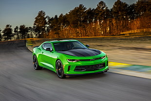 green Chevrolet Camaro on road time lapse photography