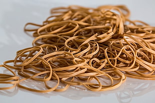 close up photo of pile of beige rubber band