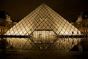 photography of glass pyramid landmark during nighttime