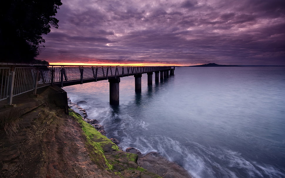 silhouette of dock under cloudy sky during sunset HD wallpaper