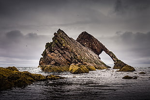 brown rock formation near large body of water, scotland HD wallpaper