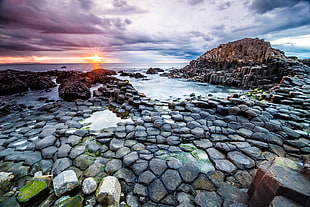 gray stones on body of water during sun set HD wallpaper