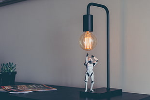 stormtrooper figure beside table lamp