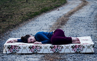woman laying on bed mattress