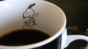 white and black ceramic mug with black coffee
