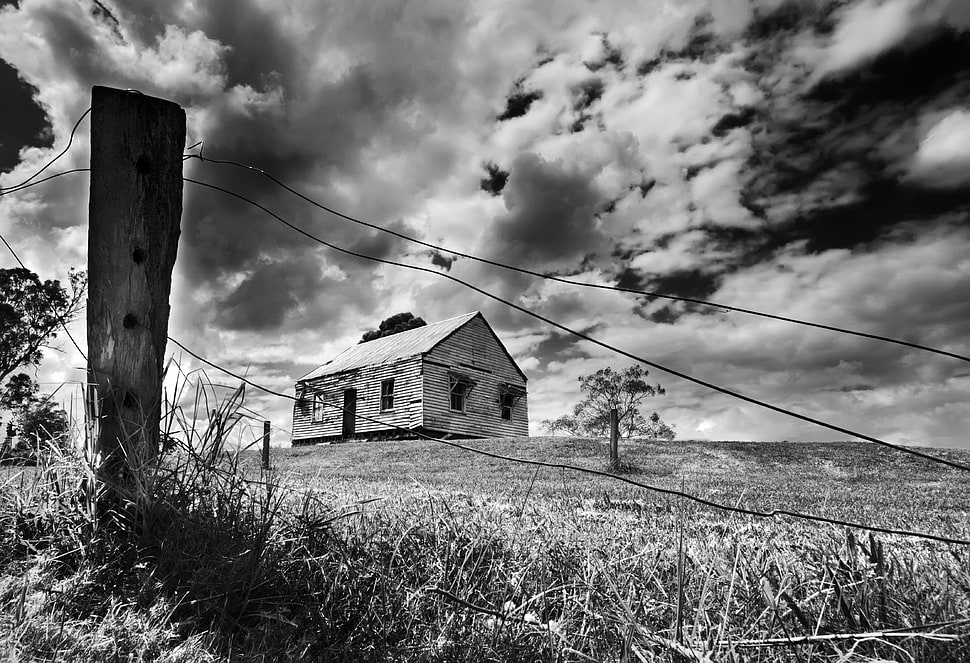 gray scale low angle view of brown house under clouds HD wallpaper