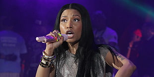 black haired woman holding wireless microphone