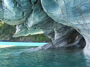 gray rock formation on body of water