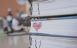 white binder books showing i love you text close up shot