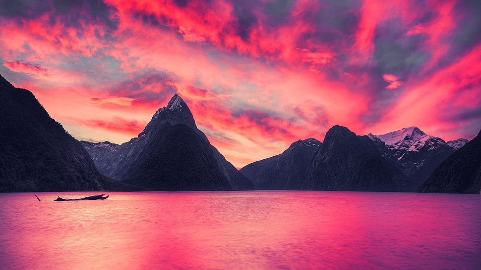 bodies of water with pointed mountain background under red sky landscape photography HD wallpaper