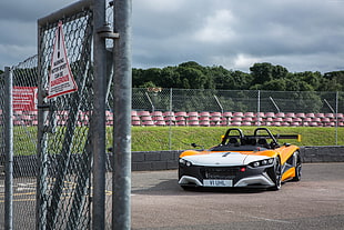 white and yellow sports car on race track