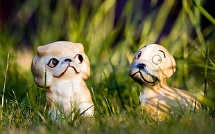 two white and brown dog ceramic figurines