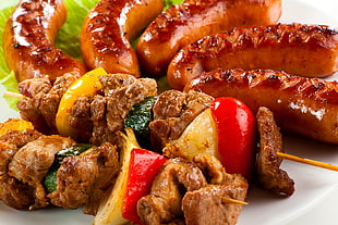 closeup photo of grilled meat with vegetables with sausages