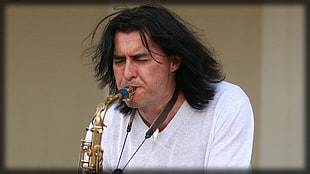 man playing brass saxophone