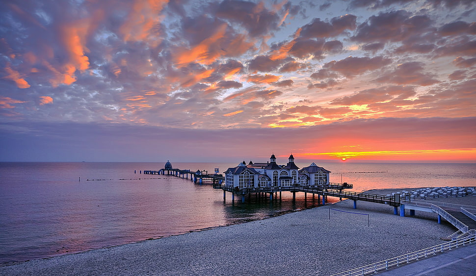 photo of house on sea dock while sunset HD wallpaper