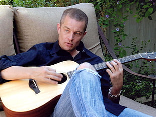 man in blue dress shirt painting natural finish acoustic guitar HD wallpaper
