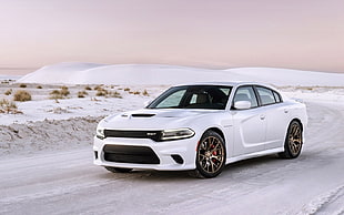 white Dodge Charger on white concrete covered by snow during daytime HD wallpaper