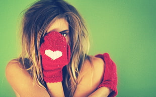 woman in red knitted gloves