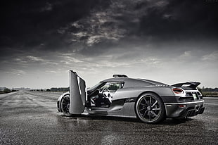 grayscale photography of sports car on concrete road