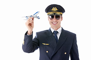 smiling male pilot holding airplane scale mode