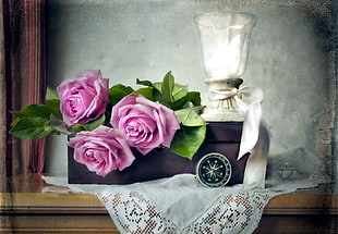 three pink roses on brown box photo