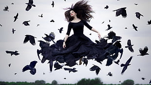 woman in black long-sleeved dress fly with flock of crow HD wallpaper