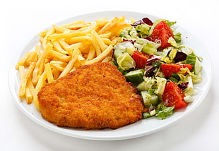 nugget and fries with vegetable salad on white ceramic plate