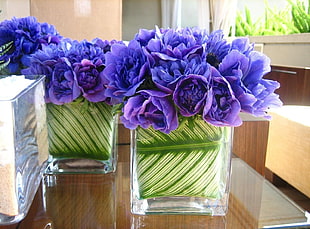 bouquet of violets in clear and green glass flower vae