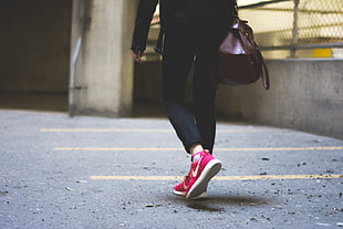 woman in pink-and-white Nike Roshe Rub