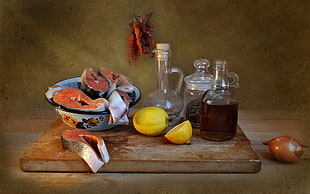 yellow lemon fruit, clear glass cruet, jar, jug, and raw fish meats, food