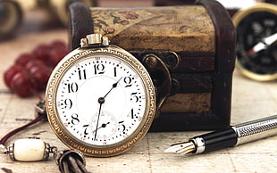 round gold pocket watch reading at 1:33