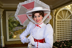 woman in white long sleeve dress holding white umbrella