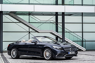 black Mercedes-Benz convertible coupe near stairs