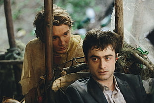 Daniel Radcliffe on chair with woman on back