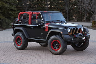 black and red Jeep Rubicon near green leafed trees
