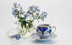 close up photo of blue and white tea cup on saucer