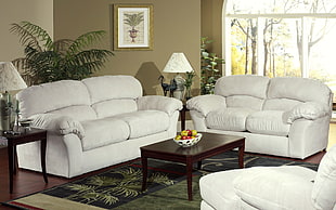 white fabric couches and coffee table