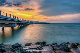 bridge and body of water during golden hour HD wallpaper