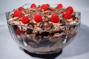 closeup photo of flavored ice cream with strawberry toppings in clear glass container